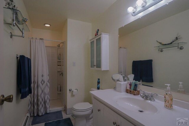 bathroom with toilet, a shower with curtain, a baseboard radiator, and vanity