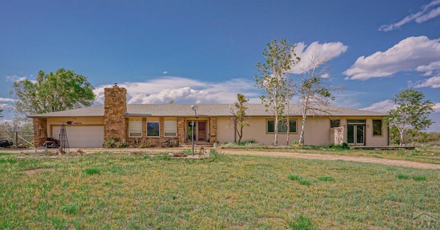 single story home with an attached garage, a chimney, and a front yard