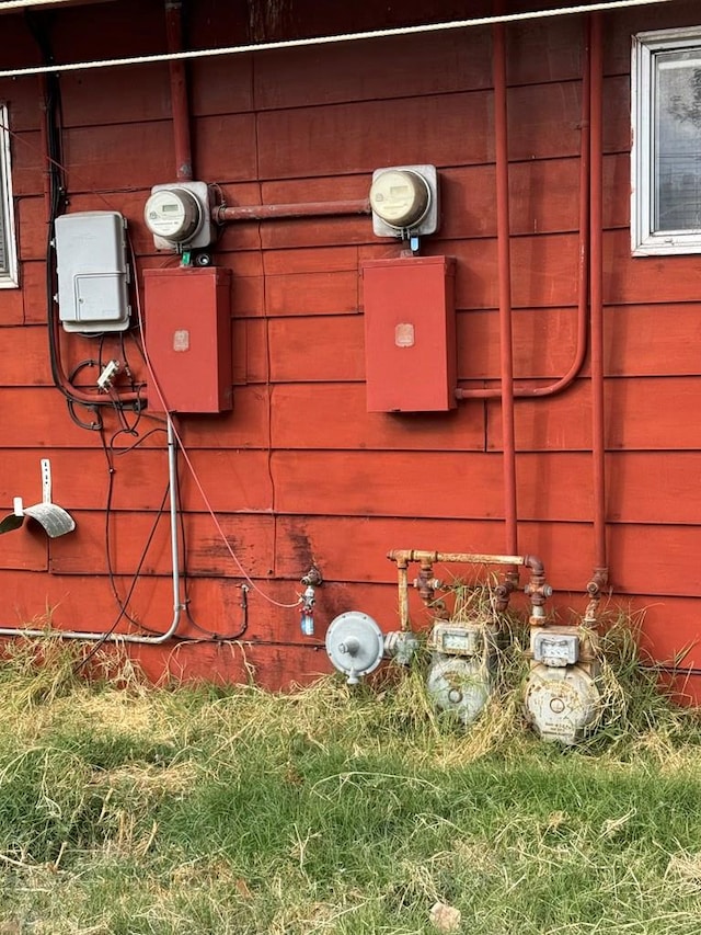 exterior details featuring electric meter and gas meter