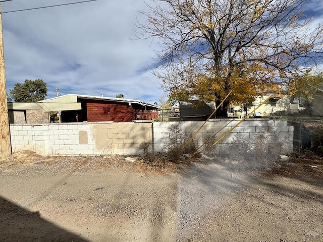 view of side of home featuring fence