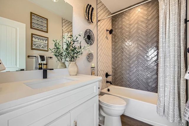 full bathroom featuring shower / bath combo, vanity, and toilet