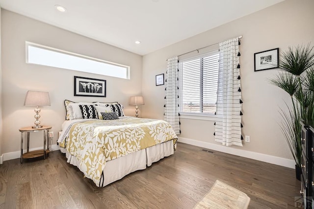 bedroom featuring visible vents, baseboards, dark wood-type flooring, and recessed lighting