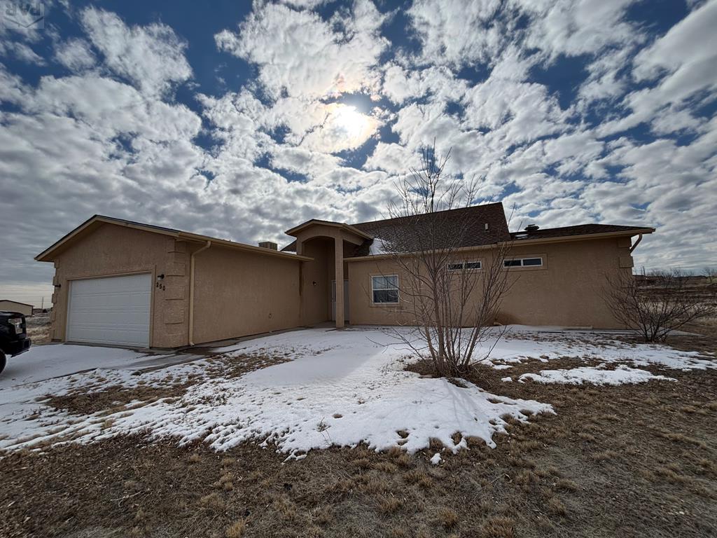 view of front of property with a garage and stucco siding