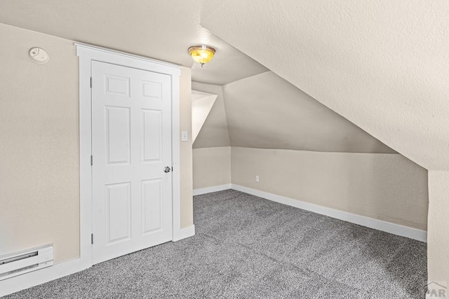 additional living space featuring lofted ceiling, carpet floors, a baseboard radiator, and baseboards