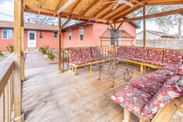 wooden terrace featuring fence, ceiling fan, and entry steps