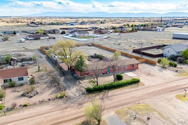 drone / aerial view featuring a mountain view, a desert view, and a residential view