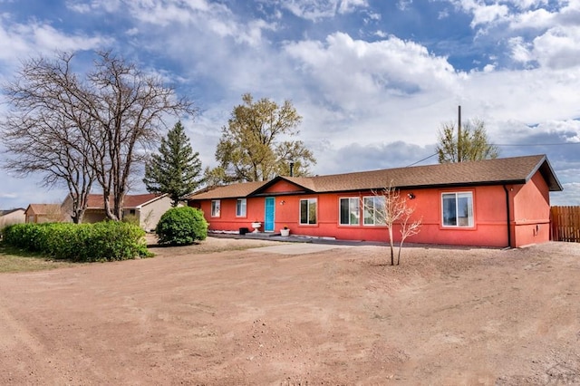ranch-style house with fence