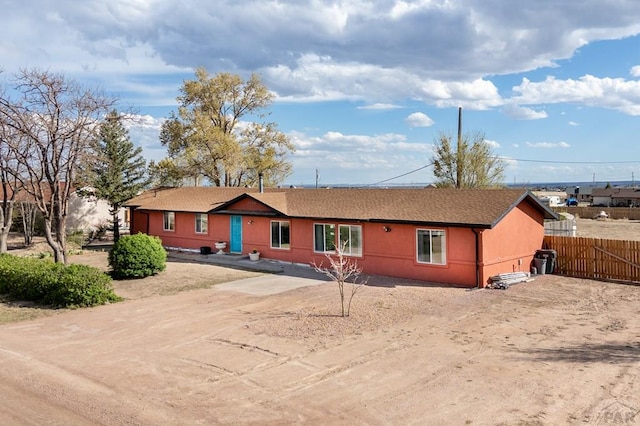 ranch-style house with fence and a shingled roof