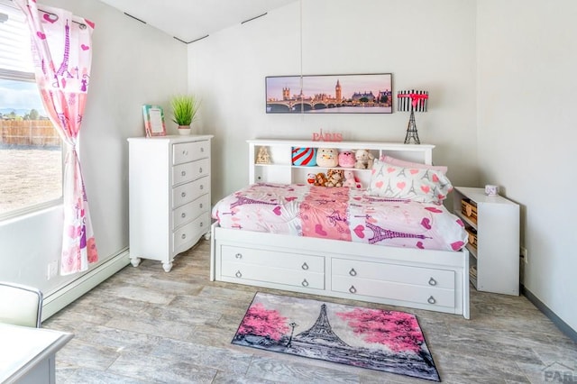 bedroom featuring a baseboard radiator and light wood finished floors