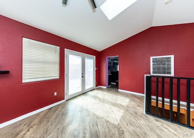 unfurnished bedroom featuring wood finished floors, baseboards, vaulted ceiling, access to exterior, and french doors