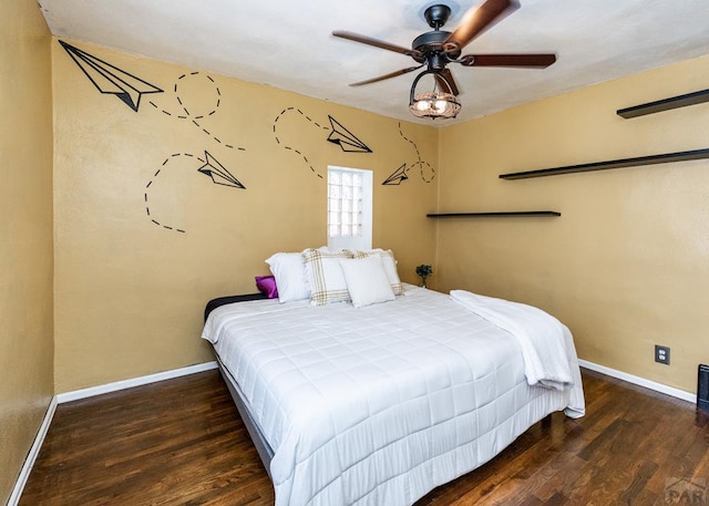 bedroom with a ceiling fan, dark wood finished floors, and baseboards