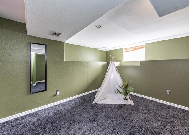 rec room with carpet floors, visible vents, and baseboards