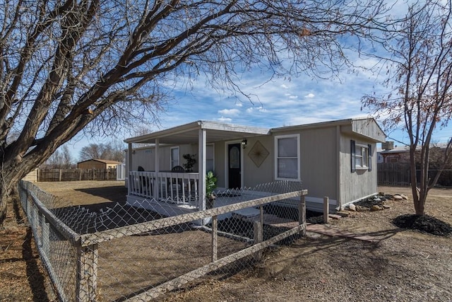 view of front of property with covered porch and a fenced front yard