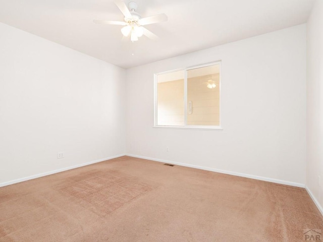 3933 Elk Ln, Pueblo, CO 81005 - empty room featuring visible vents, a ceiling fan, baseboards, and light carpet