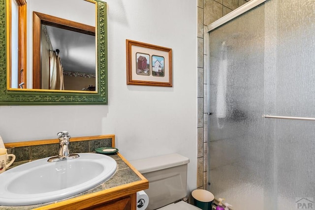 1194 39th Ln, Pueblo, CO 81006 - bathroom with vanity, toilet, and a shower stall