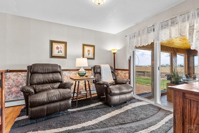 1194 39th Ln, Pueblo, CO 81006 - living area with a baseboard radiator and wood finished floors