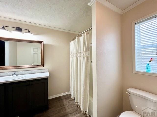 bathroom with plenty of natural light, toilet, a textured ceiling, and vanity