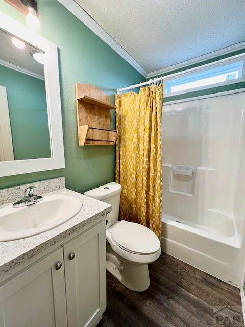 full bath with vanity, wood finished floors, a textured ceiling, crown molding, and toilet