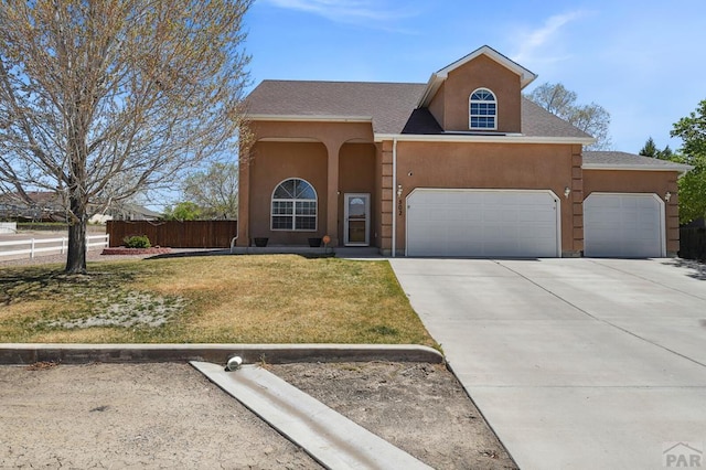 502 S Putter Dr, Pueblo West, CO 81007 - traditional-style house with an attached garage, concrete driveway, and stucco siding