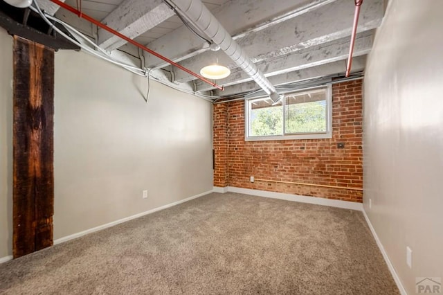 201 Lamkin Unit 205, Pueblo, CO 81003 - basement with brick wall and carpet flooring