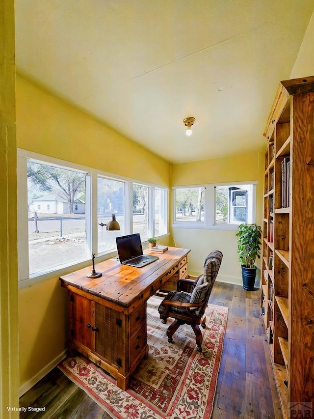 home office with dark wood-style floors and baseboards