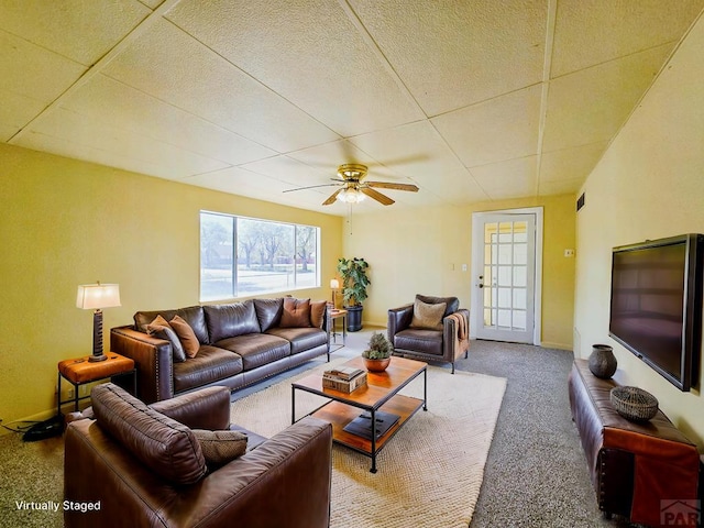 living area with a ceiling fan, carpet, and baseboards