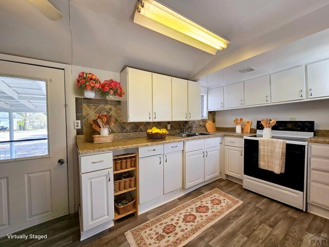 kitchen with dark wood finished floors, visible vents, white cabinetry, vaulted ceiling, and range with electric cooktop