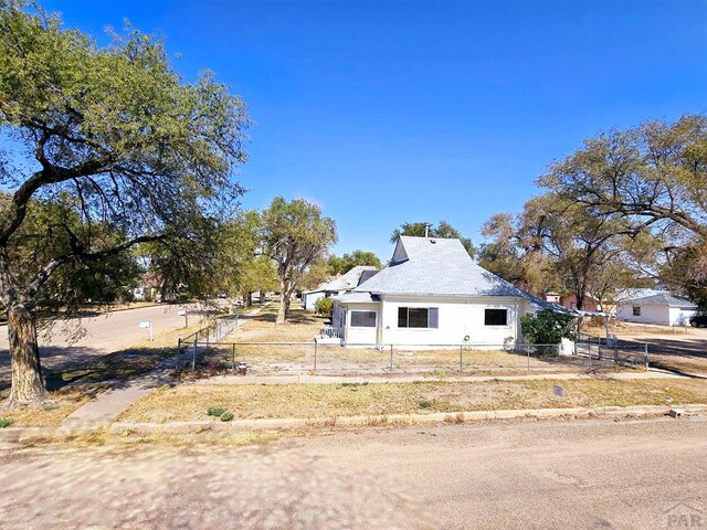 view of side of home with a fenced front yard