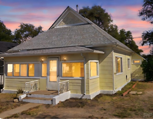 view of front of property with roof with shingles