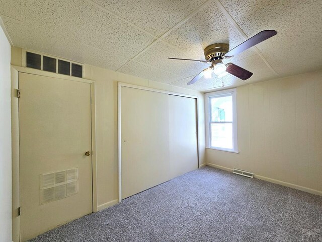 unfurnished bedroom with a closet, carpet, and visible vents