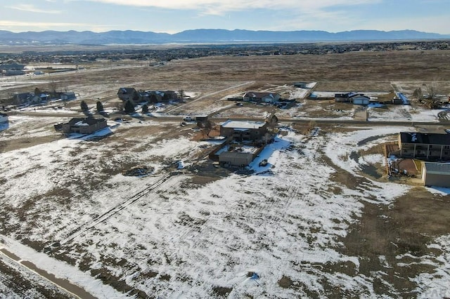 snowy aerial view with a mountain view