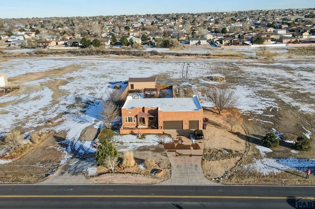 snowy aerial view with a residential view