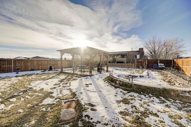 snow covered house with a fenced backyard and a pergola