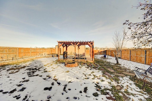 snow covered patio with a fire pit, a fenced backyard, and a pergola