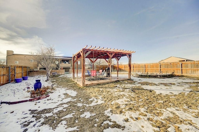 yard layered in snow with a fenced backyard and a pergola