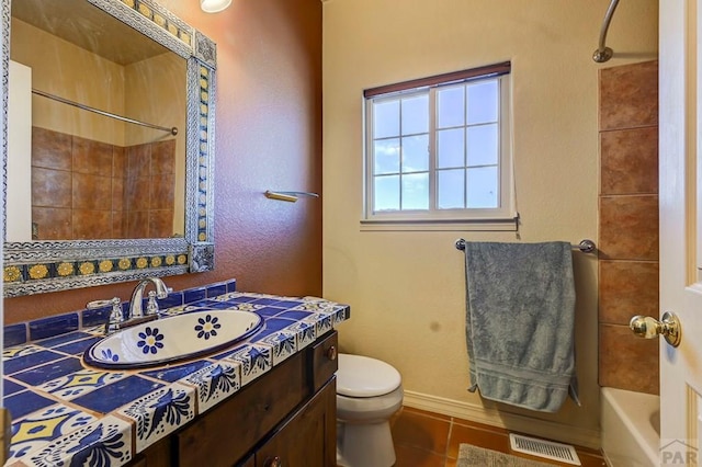 bathroom with shower / bath combination, visible vents, toilet, vanity, and tile patterned flooring