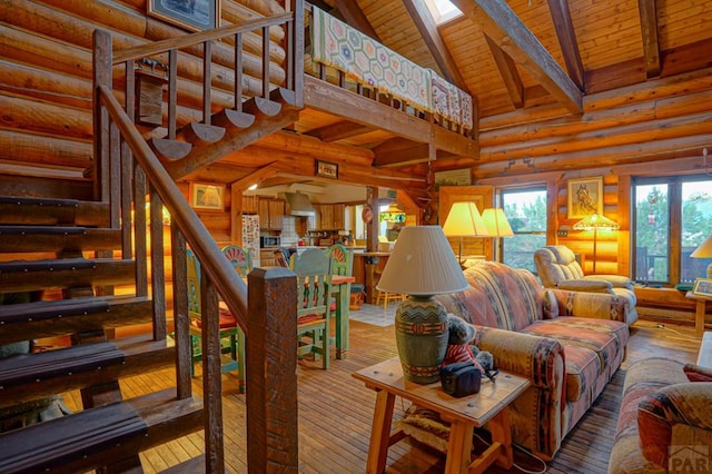 living room with a skylight, wooden ceiling, stairway, high vaulted ceiling, and beam ceiling