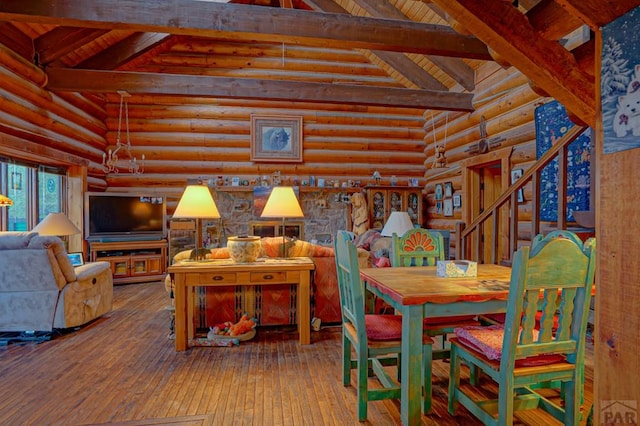 dining area with vaulted ceiling with beams, rustic walls, wooden ceiling, and wood finished floors