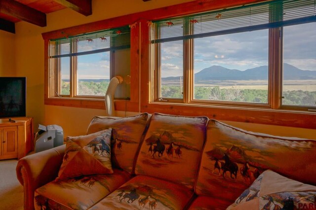 interior space featuring beamed ceiling and a mountain view