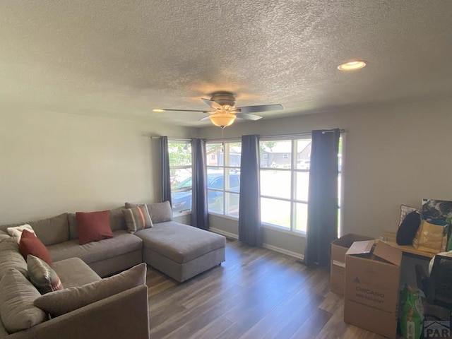 living area featuring wood finished floors, baseboards, recessed lighting, a textured ceiling, and a ceiling fan
