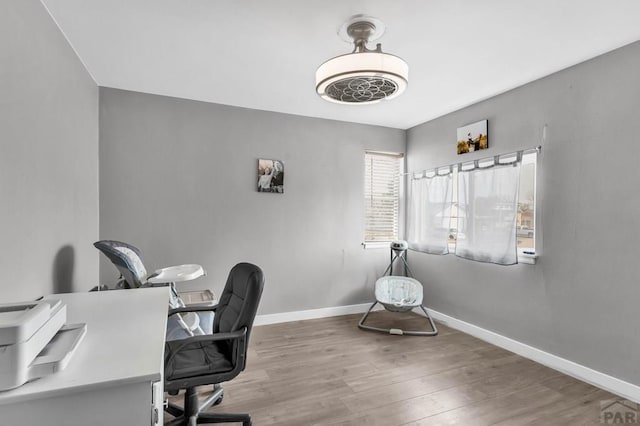 office area with baseboards and wood finished floors