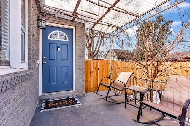 entrance to property featuring fence