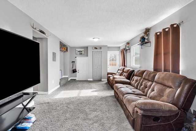 living room featuring carpet floors, a textured ceiling, and baseboards