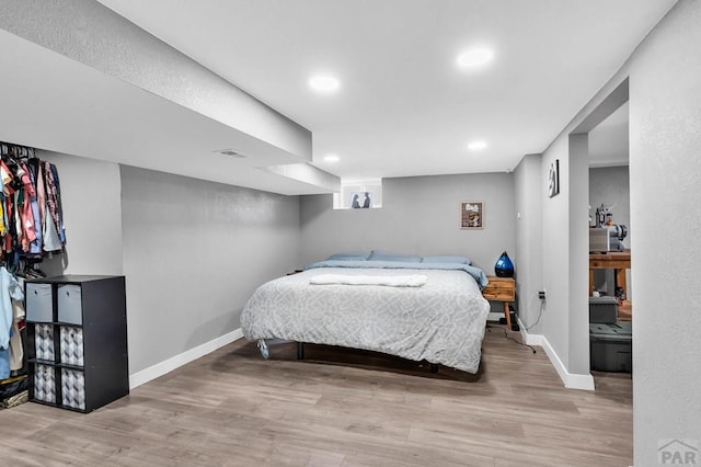 bedroom with recessed lighting, light wood-type flooring, visible vents, and baseboards