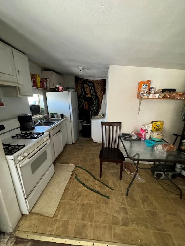 1718 E Abriendo Ave, Pueblo, CO 81004 - kitchen with white appliances, a sink, under cabinet range hood, white cabinets, and a textured ceiling
