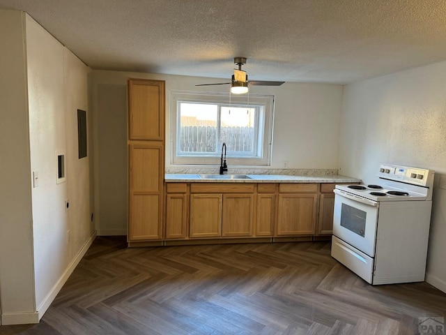 1718 E Abriendo Ave, Pueblo, CO 81004 - kitchen featuring electric range, a sink, a textured ceiling, light countertops, and a ceiling fan