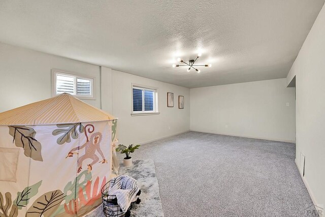 interior space featuring a notable chandelier, baseboards, and a textured ceiling