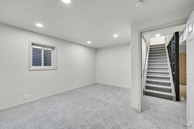 finished below grade area featuring baseboards, carpet floors, stairs, and recessed lighting