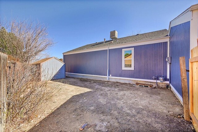 rear view of house with fence