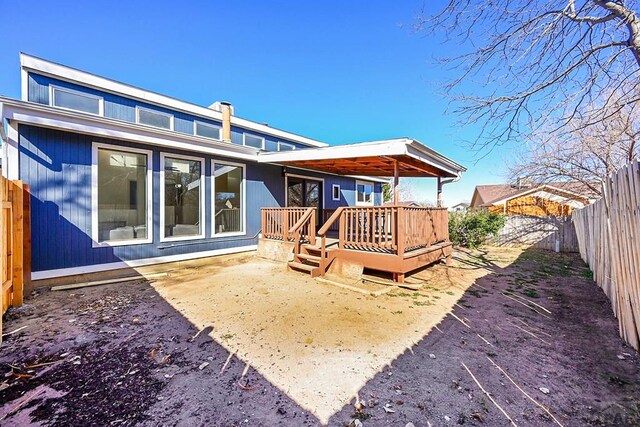 back of house featuring a wooden deck and a fenced backyard